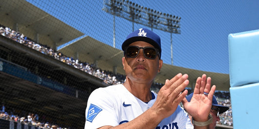 Dave Roberts in basn5 davenport sunglasses applauding at Dodger Stadium
