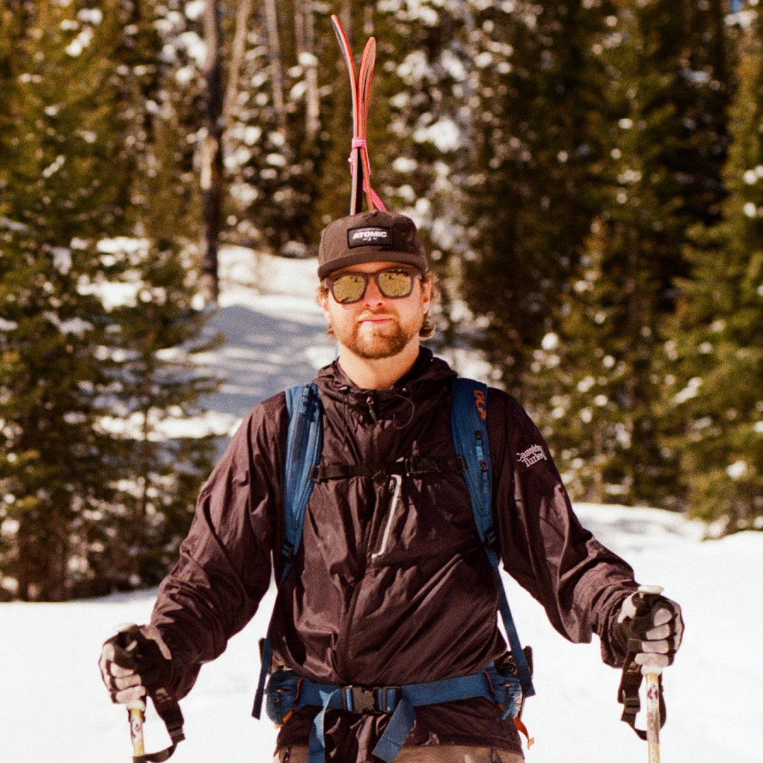 Ski touring with skis shouldered, wearing basn5 Davenport