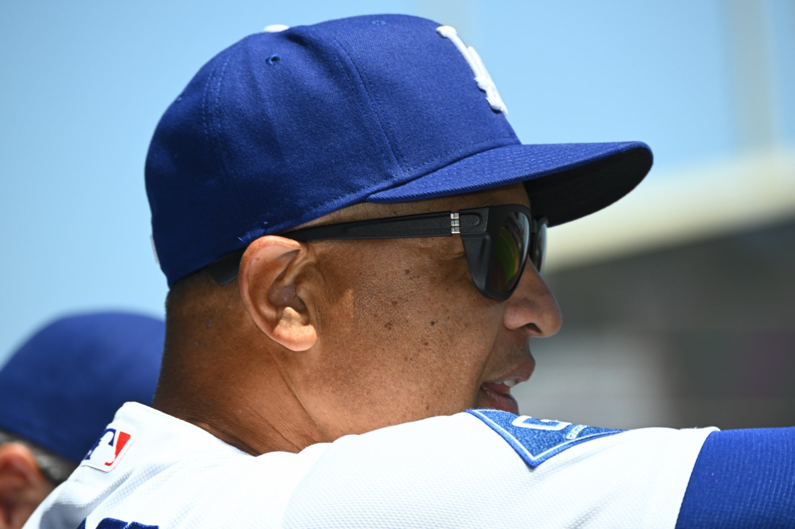 Side profile of Dave Roberts wearing the basn5 davenport at Dodger Stadium
