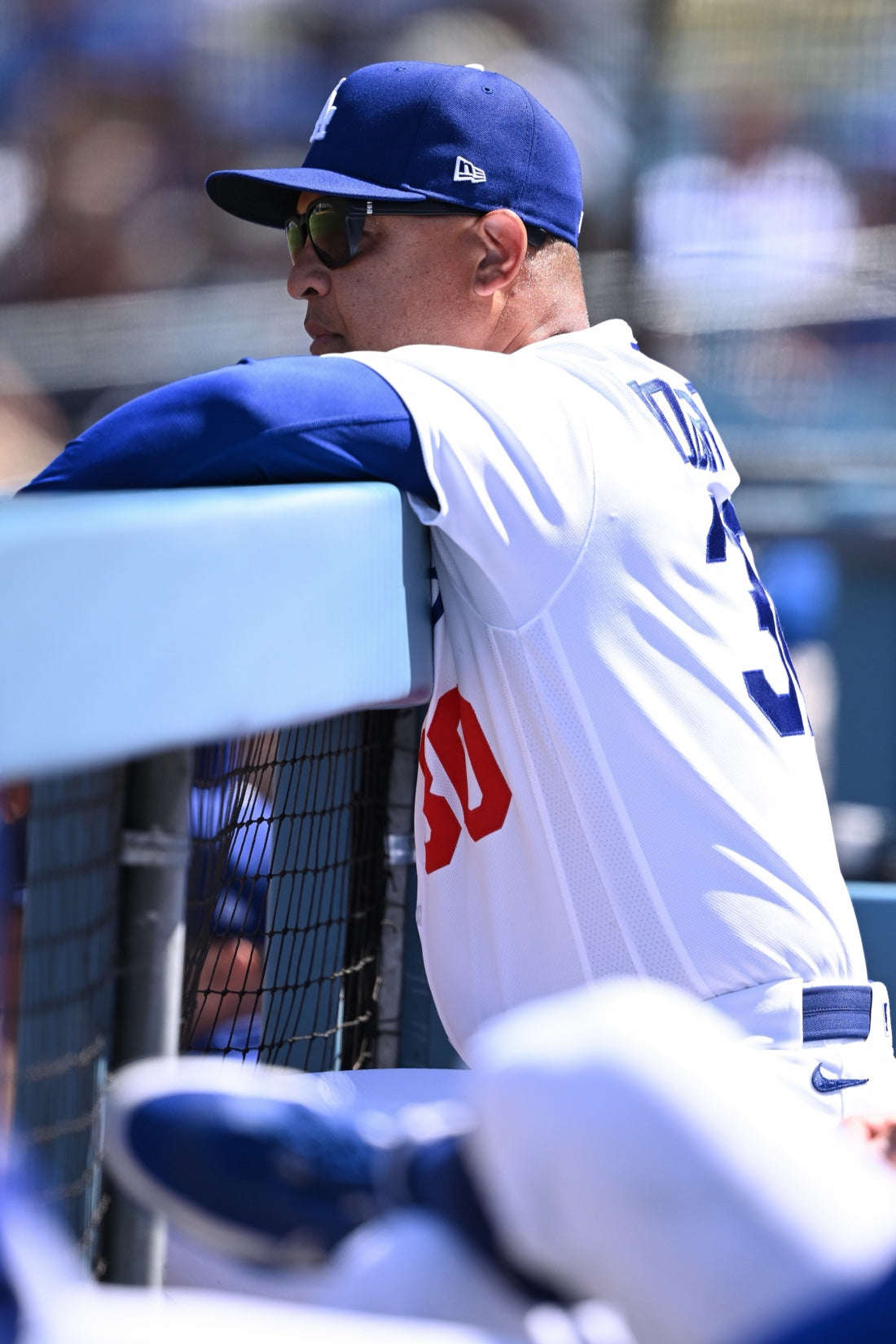 Dave Roberts in the basn5 davenport leaning on the dugout rail at Dodger Stadium