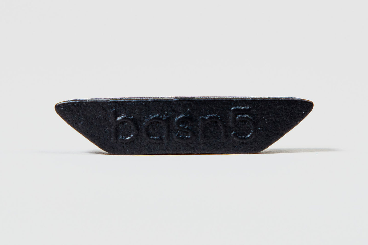wind plug — small press-fit accessory with basn5 embossed on its face