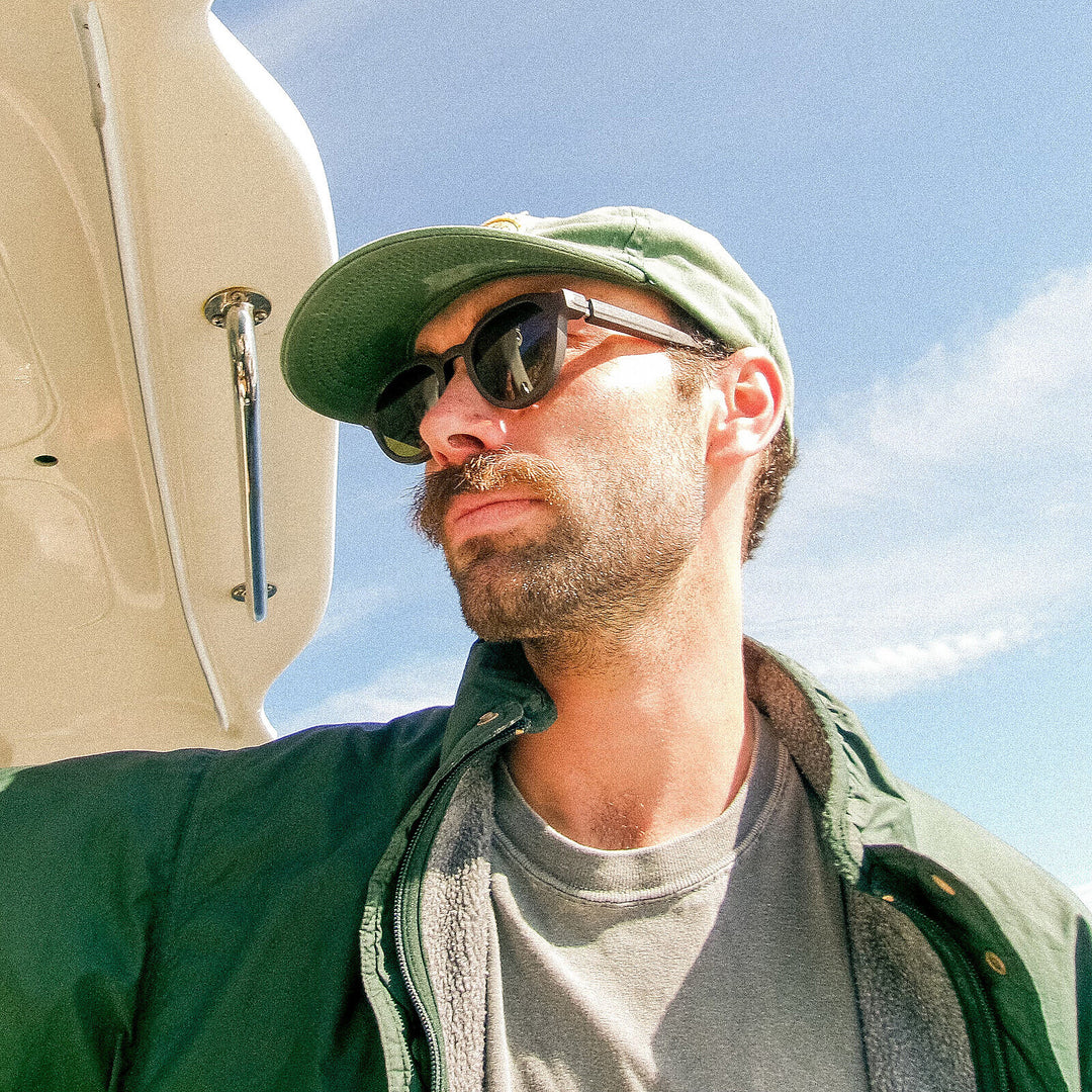 Quinn in green jacket on a boat, wearing basn5 Highway 1