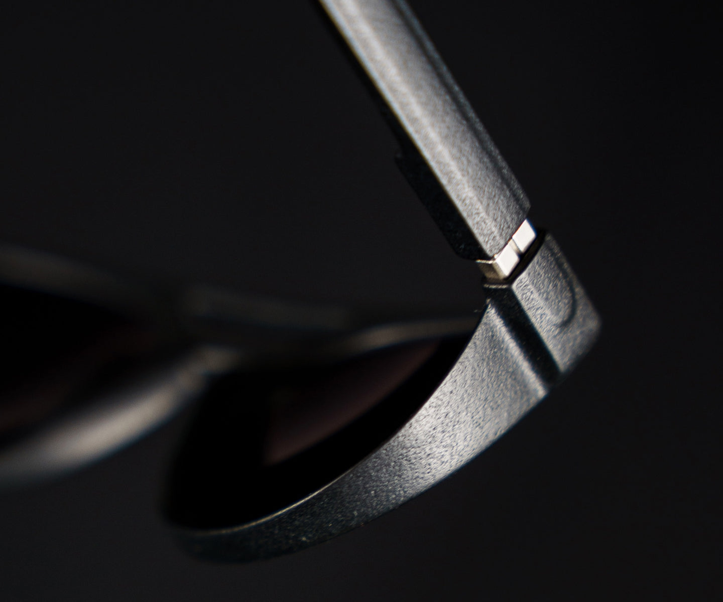 Macro detail of basn5 frame edge — visible matte texture against the temple